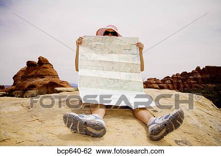 Stock Image - Tourist reading map, Moab, Canyonlands, Utah, United States. Fotosearch