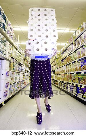 Woman carrying stack of toilet paper in supermarket View Large Photo Image Stock Image - Woman carrying stack of toilet paper in supermarket. Fotosearch