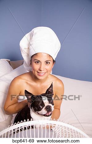 Stock Photo - Woman drying herself and her dog by fan. Fotosearch