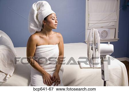 Stock Photo - Woman drying off with a fan. Fotosearch