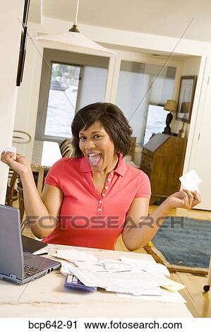 Woman happily tearing mail View Large Photo Image Stock Image - Woman happily tearing mail. Fotosearch