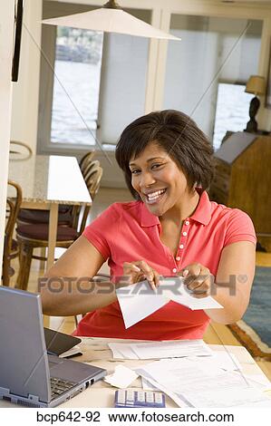 Woman happily tearing mail View Large Photo Image Stock Image - Woman happily tearing mail. Fotosearch