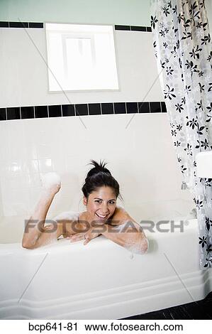 Woman playing with bubbles in bathtub View Large Photo Image Stock Image - Woman playing with bubbles in bathtub. Fotosearch