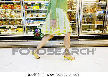 Woman shopping in supermarket View Large Photo Image Stock Image - Woman shopping in supermarket. Fotosearch