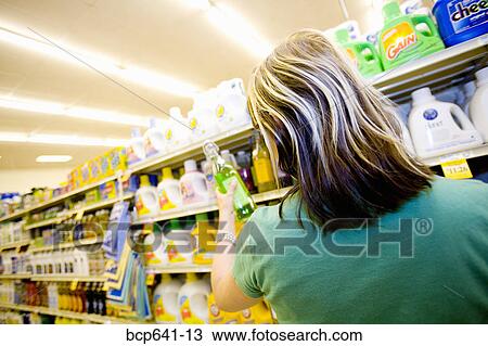 Stock Image - Woman shopping in supermarket. Fotosearch