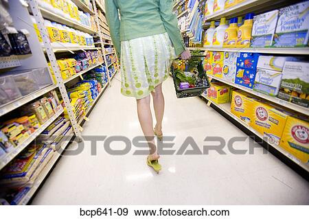 Stock Photo - Woman shopping in supermarket. Fotosearch