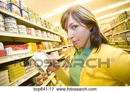 Woman shopping in supermarket View Large Photo Image Stock Photo - Woman shopping in supermarket. Fotosearch