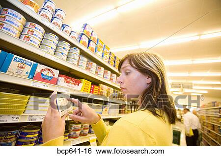 Woman shopping in supermarket View Large Photo Image Stock Photograph - Woman shopping in supermarket. Fotosearch