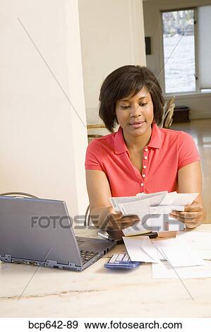 Woman sorting through mail View Large Photo Image Stock Photo - Woman sorting through mail. Fotosearch