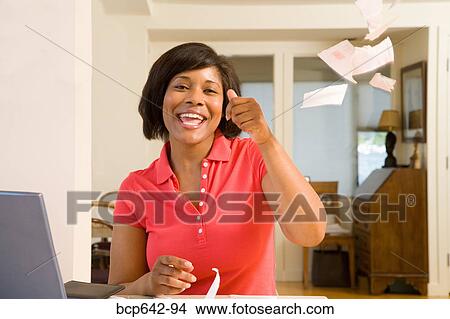 Picture - Woman throwing torn mail in celebration. Fotosearch