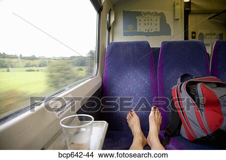 Woman’s bare feet propped up on a train seat View Large Photo Image Picture - Woman’s bare feet propped up on a train seat. Fotosearch