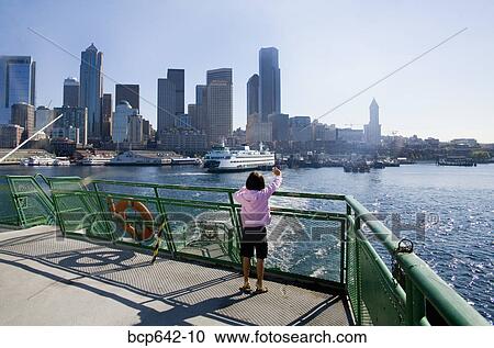 Young girl standing on dock overlooking city bay View Large Photo Image Stock Image - Young girl standing on dock overlooking city bay. Fotosearch