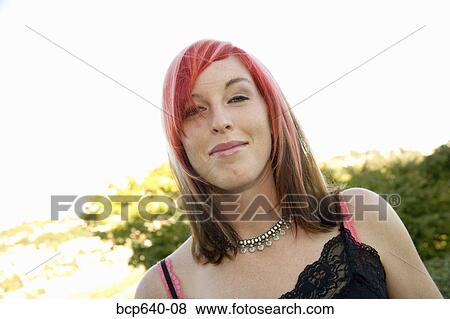 Young woman with dyed hair smiling View Large Photo Image Stock Photo - Young woman with dyed hair smiling. Fotosearch