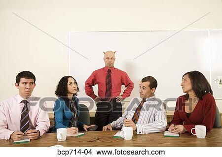 Picture - Angry businesspeople next to boss with horns over head. Fotosearch