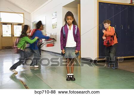 Blurred motion shot of students running past girl View Large Photo Image Stock Photo - Blurred motion shot of students running past girl. Fotosearch