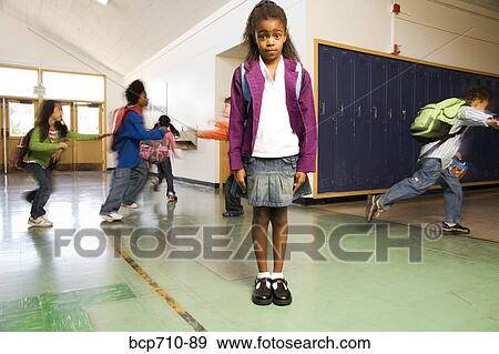 Blurred motion shot of students running past girl View Large Photo Image Stock Photo - Blurred motion shot of students running past girl. Fotosearch