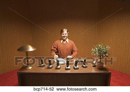 Businessman at desk with multiple telephones View Large Photo Image Stock Image - Businessman at desk with multiple telephones. Fotosearch