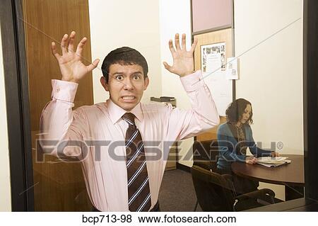 Businessman clawing on window View Large Photo Image Stock Photo - Businessman clawing on window. Fotosearch