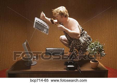 Businessman dressed as caveman crouching on desk View Large Photo Image Stock Photography - Businessman dressed as caveman crouching on desk. Fotosearch