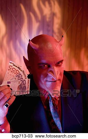 Businessman dressed as devil holding money View Large Photo Image Stock Image - Businessman dressed as devil holding money. Fotosearch