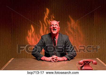 Stock Photo - Businessman dressed as devil laughing. Fotosearch