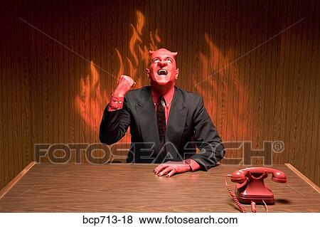 Stock Photo - Businessman dressed as devil laughing. Fotosearch