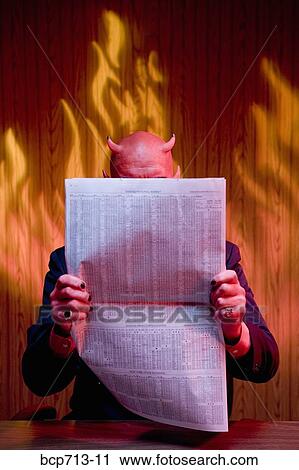 Businessman dressed as devil reading newspaper View Large Photo Image Stock Image - Businessman dressed as devil reading newspaper. Fotosearch