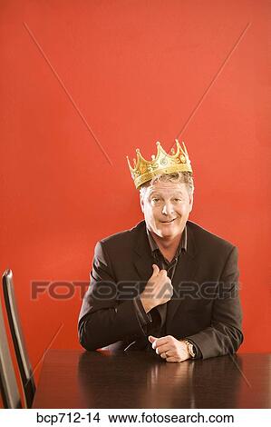 Businessman wearing gold crown in conference room View Large Photo Image Picture - Businessman wearing gold crown in conference room. Fotosearch
