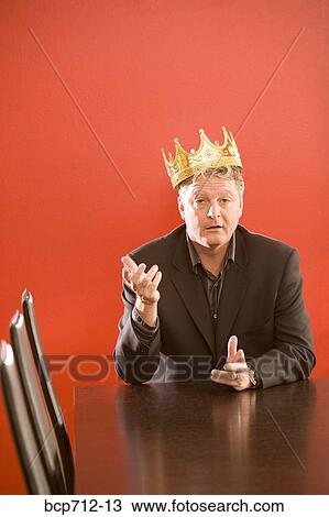 Businessman wearing gold crown in conference room View Large Photo Image Stock Image - Businessman wearing gold crown in conference room. Fotosearch