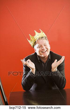 Businessman wearing gold crown in conference room View Large Photo Image Stock Photography - Businessman wearing gold crown in conference room. Fotosearch