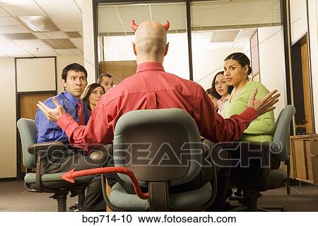 Businessman with devil horns and tail at meeting View Large Photo Image Stock Image - Businessman with devil horns and tail at meeting. Fotosearch