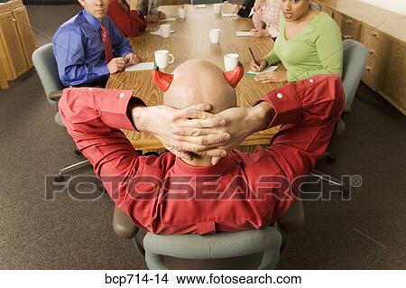 Businessman with devil horns at meeting View Large Photo Image Picture - Businessman with devil horns at meeting. Fotosearch