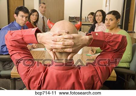 Businessman with devil horns at meeting View Large Photo Image Stock Image - Businessman with devil horns at meeting. Fotosearch