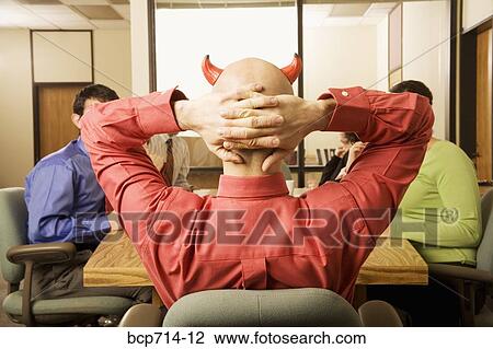 Businessman with devil horns at meeting View Large Photo Image Stock Image - Businessman with devil horns at meeting. Fotosearch