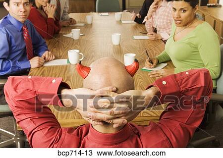 Businessman with devil horns at meeting View Large Photo Image Stock Image - Businessman with devil horns at meeting. Fotosearch