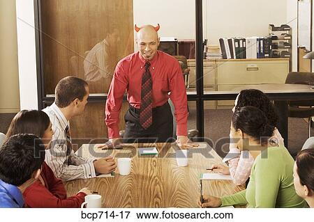 Businessman with devil horns at meeting View Large Photo Image Stock Photo - Businessman with devil horns at meeting. Fotosearch