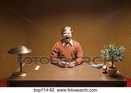 Businessman yawning at desk View Large Photo Image Stock Image - Businessman yawning at desk. Fotosearch