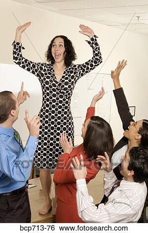 Stock Photograph - Businesspeople acting silly in office. Fotosearch