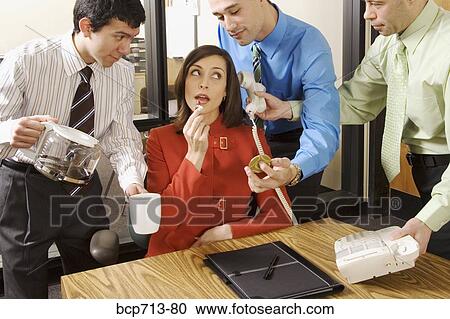 Stock Image - Businesswoman with three male assistants. Fotosearch
