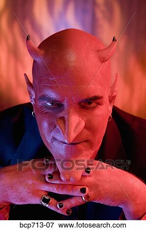 Close up of businessman dressed as devil View Large Photo Image Stock Photo - Close up of businessman dressed as devil. Fotosearch