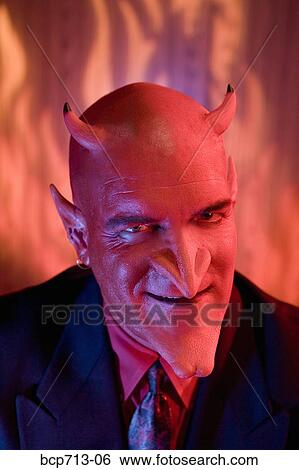 Close up of businessman dressed as devil View Large Photo Image Stock Photograph - Close up of businessman dressed as devil. Fotosearch