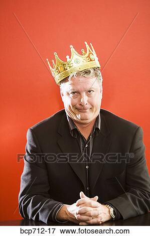 Close up of businessman wearing gold crown View Large Photo Image Stock Photo - Close up of businessman wearing gold crown. Fotosearch