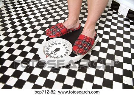 Close up of person standing on bathroom scale View Large Photo Image Stock Image - Close up of person standing on bathroom scale. Fotosearch