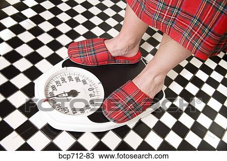 Close up of person standing on bathroom scale View Large Photo Image Stock Image - Close up of person standing on bathroom scale. Fotosearch
