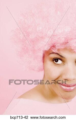 Close up of woman wearing pink wig View Large Photo Image Stock Image - Close up of woman wearing pink wig. Fotosearch