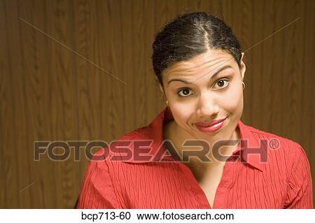 Stock Image - Close up of woman with eyebrows raised. Fotosearch