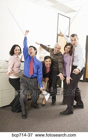 co-workers cheering next to photocopier machine View Large Photo Image Stock Photo - co-workers cheering next to photocopier machine. Fotosearch