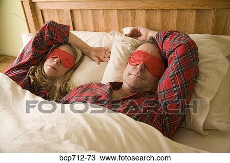 Couple sleeping with eye mask View Large Photo Image Stock Image - Couple sleeping with eye mask. Fotosearch