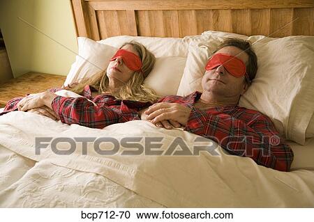 Couple sleeping with eye masks View Large Photo Image Stock Image - Couple sleeping with eye masks. Fotosearch