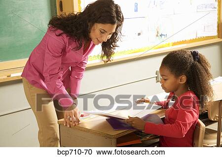 Female teacher helping student View Large Photo Image Stock Image - Female teacher helping student. Fotosearch